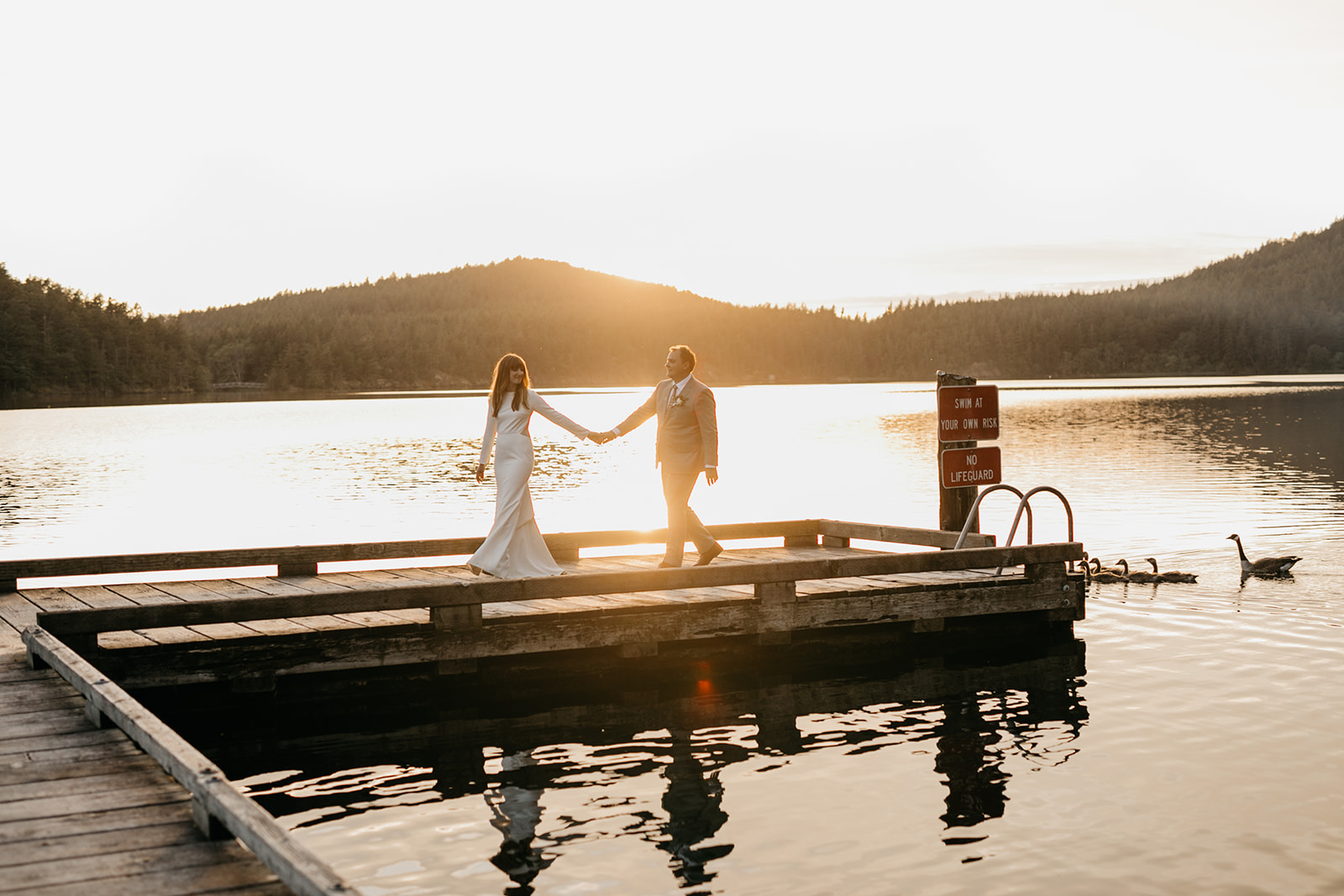 wedding couple on dock of lake moran on orcas island