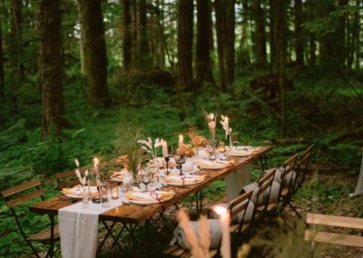 tables_set_up_in_forest_for_wedding_reception