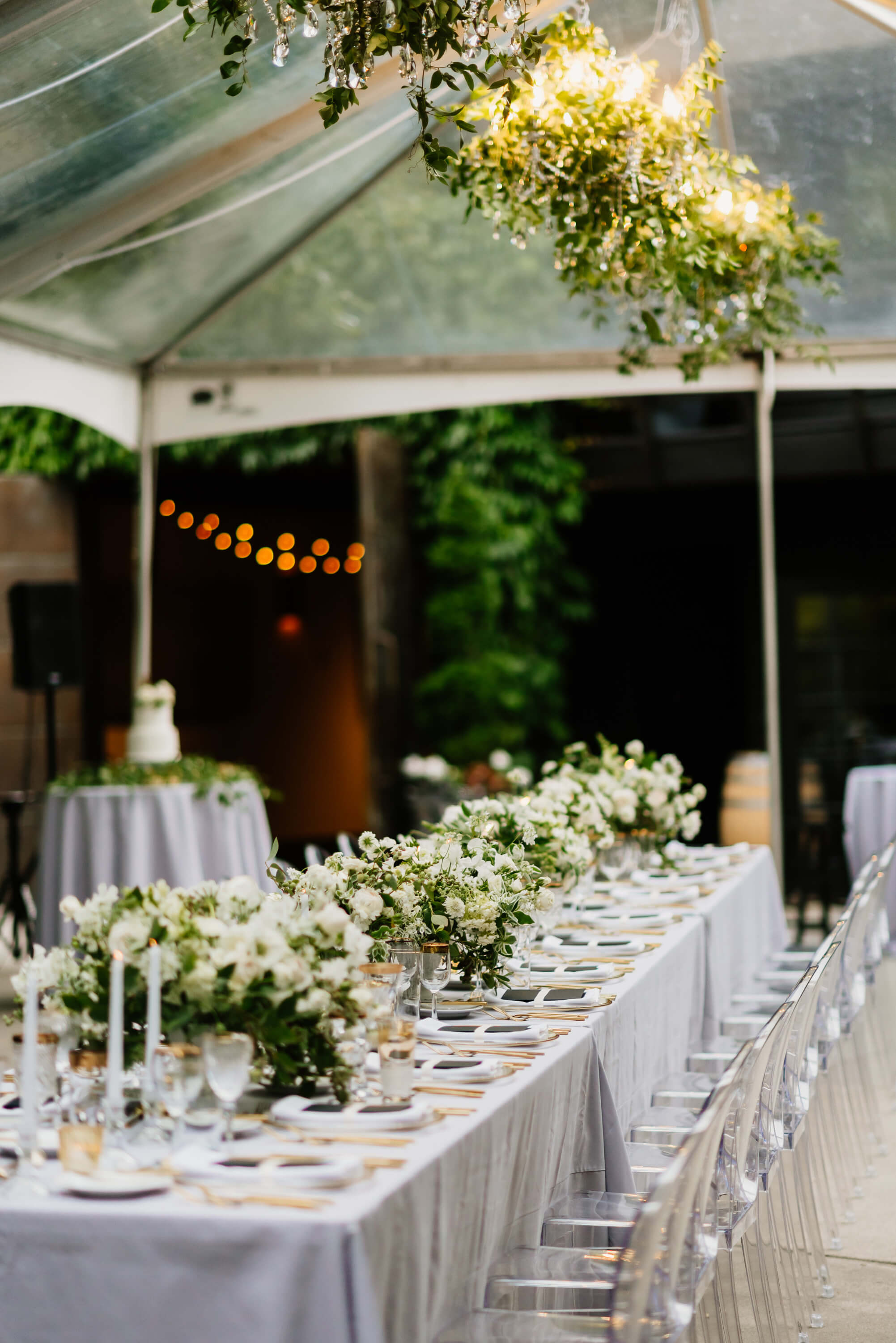 wedding reception under clear tent long table under clear tent